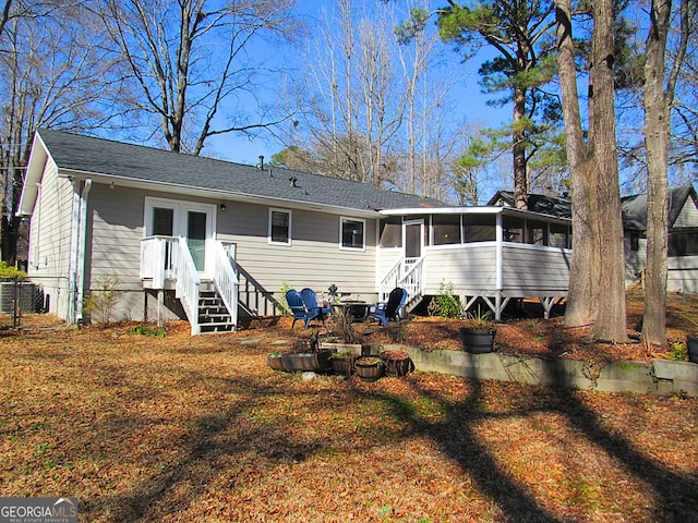 back of house featuring a sunroom and central AC unit