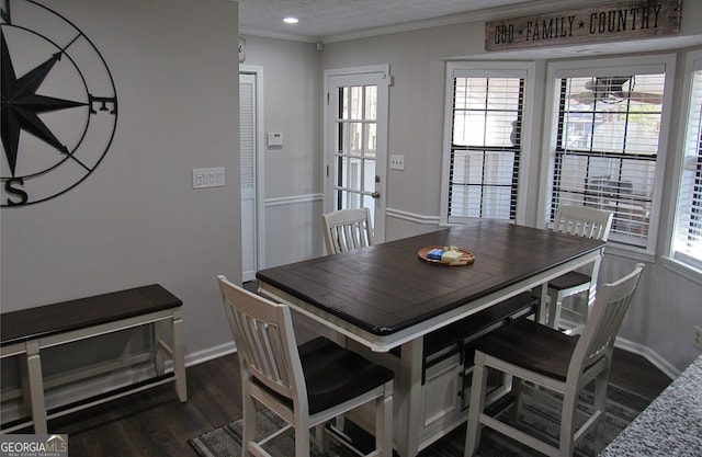 dining space featuring dark hardwood / wood-style flooring and ornamental molding