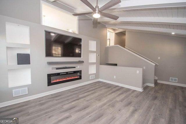 unfurnished living room with ceiling fan, wood-type flooring, and lofted ceiling with beams