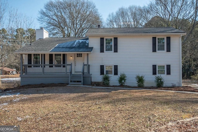 tri-level home with a front yard and a porch