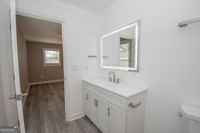 bathroom with vanity, wood-type flooring, and toilet