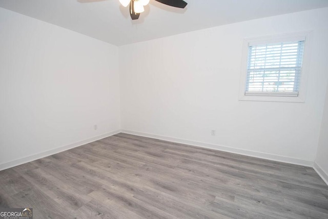 empty room with wood-type flooring and ceiling fan