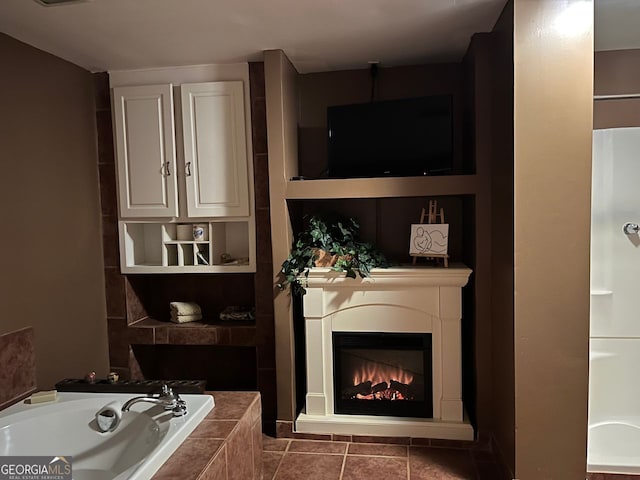 bathroom with a relaxing tiled tub, built in features, and tile patterned floors