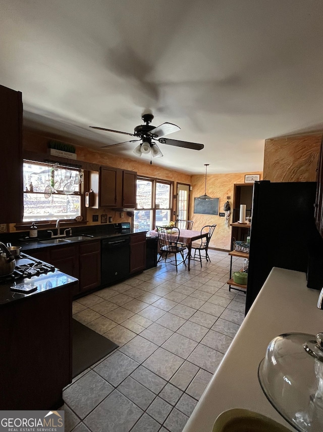 kitchen with dark brown cabinetry, sink, light tile patterned floors, ceiling fan, and black appliances