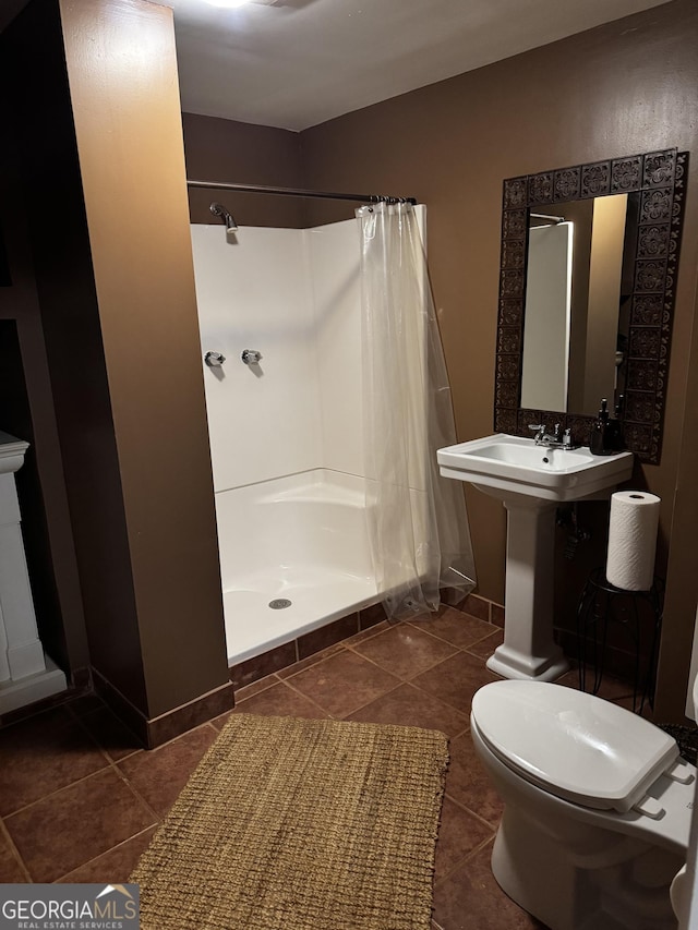 bathroom featuring sink, toilet, and walk in shower