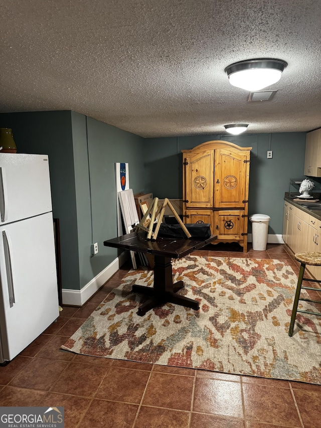 dining room with a textured ceiling