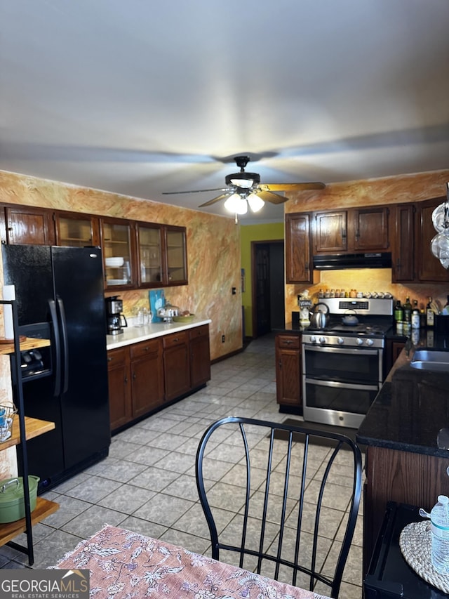 kitchen with ceiling fan, double oven range, black refrigerator with ice dispenser, and dark brown cabinets