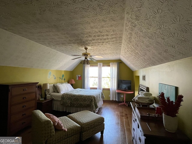 bedroom featuring ceiling fan, dark hardwood / wood-style floors, vaulted ceiling, and a textured ceiling