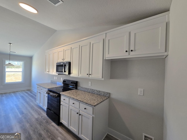 kitchen featuring hardwood / wood-style floors, pendant lighting, white cabinets, and black / electric stove