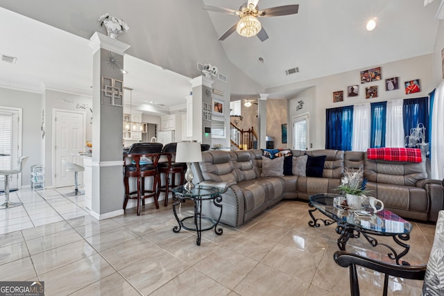 living room featuring light tile patterned floors, crown molding, ceiling fan, high vaulted ceiling, and ornate columns