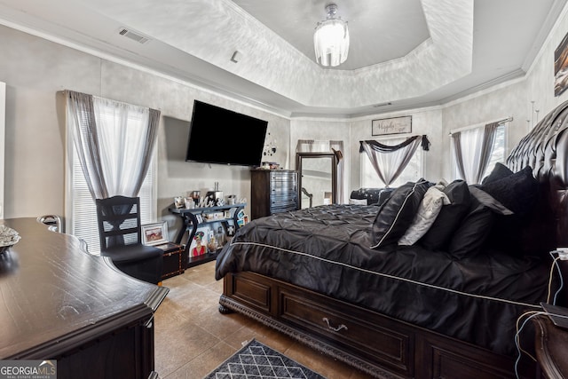 tiled bedroom with crown molding and a raised ceiling