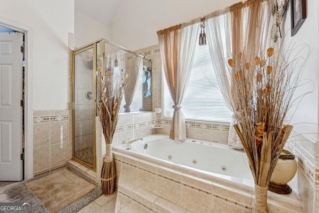 bathroom with tile patterned flooring, plenty of natural light, and shower with separate bathtub