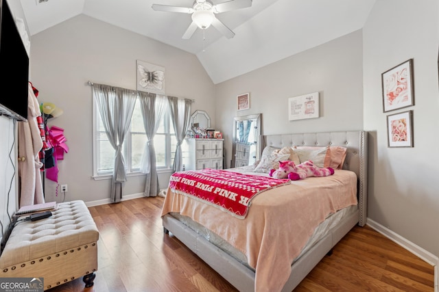 bedroom with hardwood / wood-style flooring, ceiling fan, and vaulted ceiling