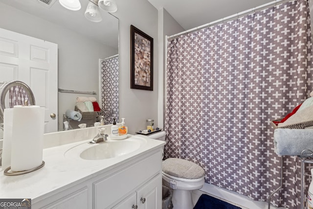 bathroom featuring vanity and toilet