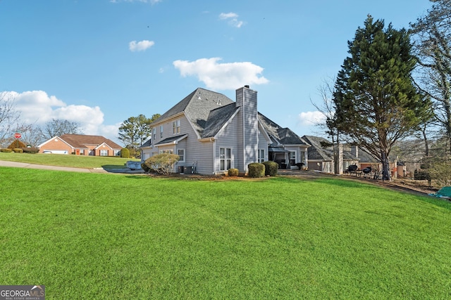 view of side of property with a lawn