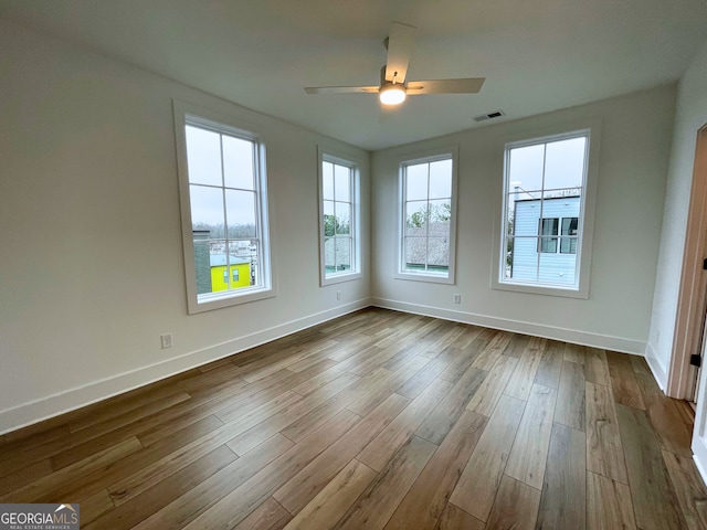 empty room featuring hardwood / wood-style flooring and ceiling fan