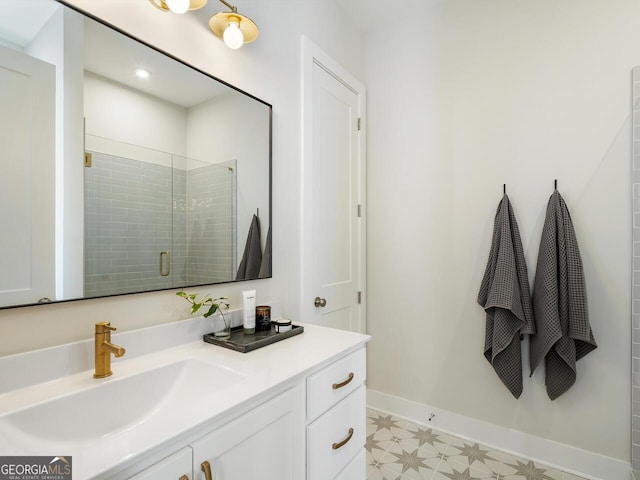 bathroom with a shower with door and vanity