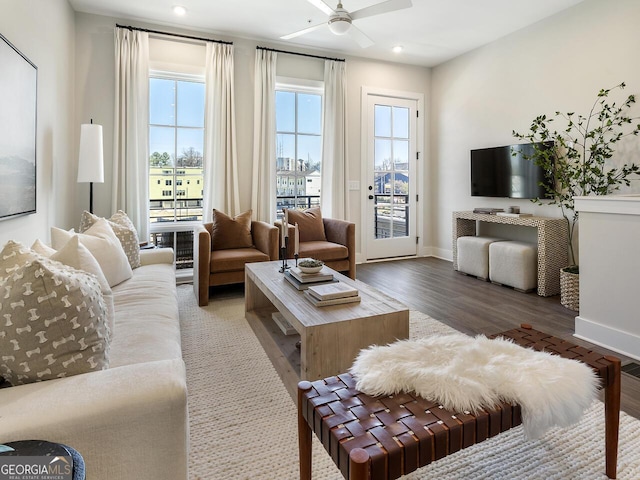 living room featuring dark hardwood / wood-style flooring, plenty of natural light, and ceiling fan