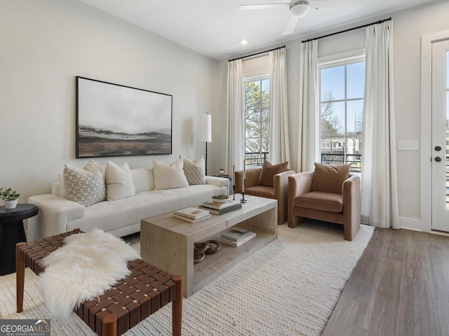 living room featuring hardwood / wood-style flooring and ceiling fan