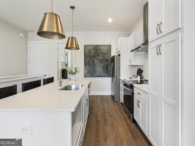 kitchen with wall chimney exhaust hood, sink, white cabinetry, hanging light fixtures, and appliances with stainless steel finishes