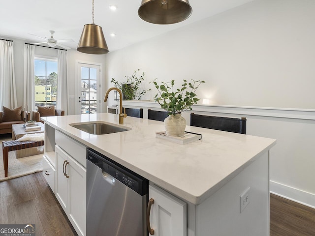 kitchen featuring white cabinetry, sink, hanging light fixtures, a kitchen island with sink, and stainless steel dishwasher