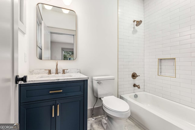 full bathroom with tiled shower / bath, vanity, and toilet