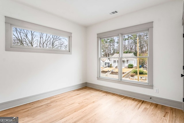 unfurnished room featuring light hardwood / wood-style flooring