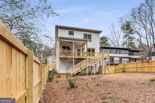 back of property with a wooden deck and ceiling fan