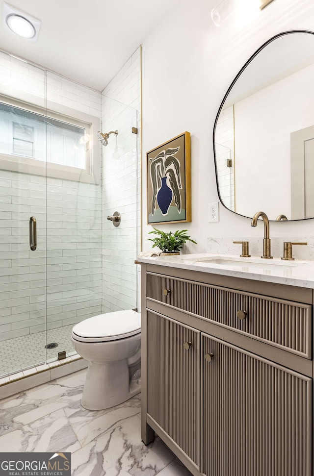 bathroom with vanity, toilet, and an enclosed shower