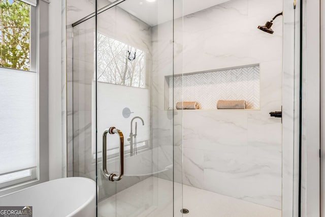 bathroom featuring plenty of natural light and plus walk in shower