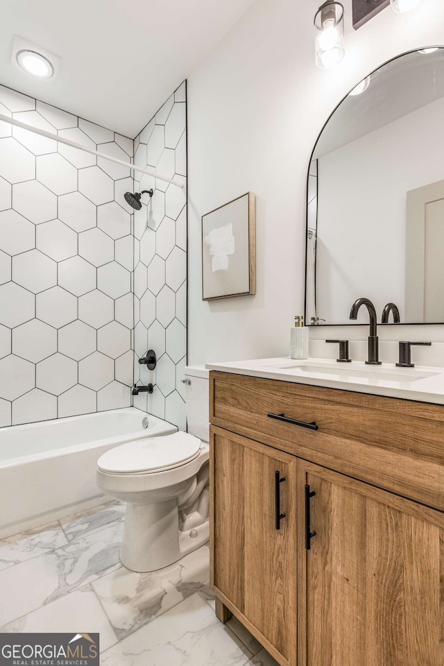 full bathroom featuring vanity, toilet, and tiled shower / bath