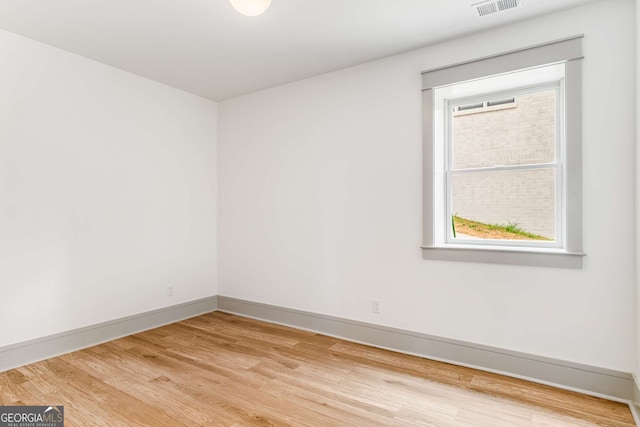 unfurnished room with hardwood / wood-style flooring