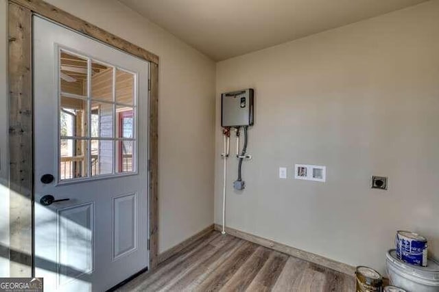 laundry room with electric dryer hookup, washer hookup, and wood-type flooring