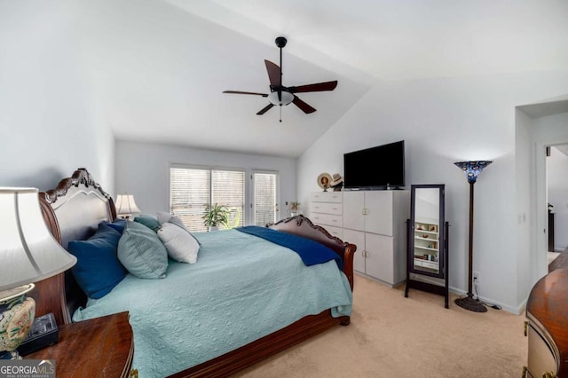 bedroom featuring vaulted ceiling, light colored carpet, and ceiling fan