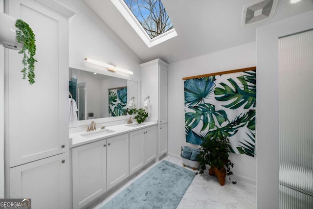 bathroom featuring vanity and lofted ceiling with skylight