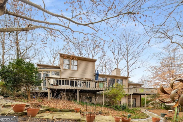 rear view of property featuring a deck