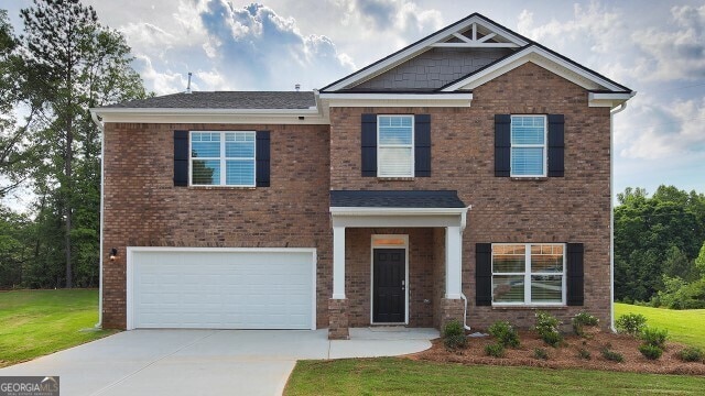 view of front of property with a garage and a front yard