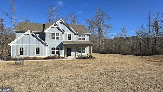 view of front of house with a front yard and covered porch