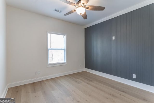 unfurnished room featuring baseboards, ceiling fan, visible vents, and light wood finished floors