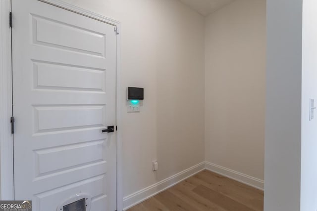 interior space with baseboards and wood finished floors