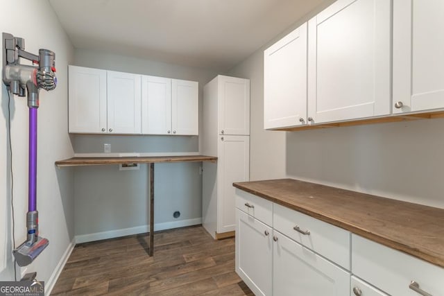 laundry area featuring dark wood-style floors and baseboards