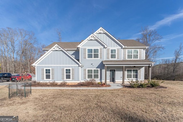 craftsman-style home featuring board and batten siding, a porch, and a front lawn