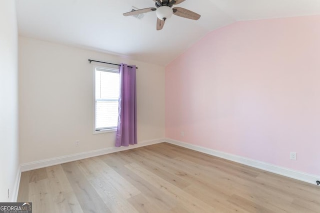 unfurnished room featuring lofted ceiling, light wood-type flooring, baseboards, and a ceiling fan