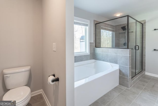 full bath featuring a garden tub, toilet, a shower stall, tile patterned flooring, and baseboards