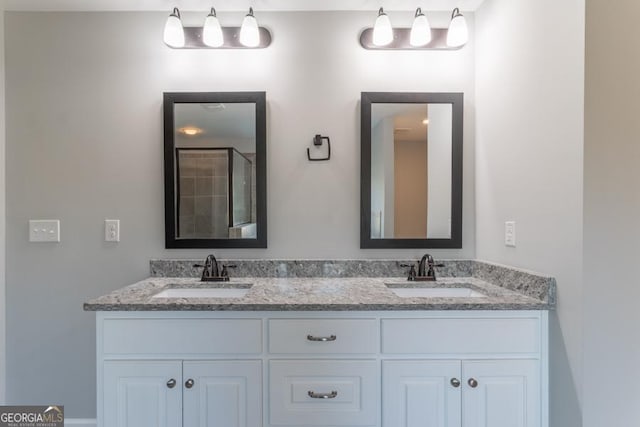 full bathroom with double vanity, a tile shower, and a sink