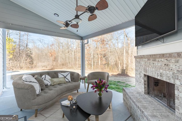 exterior space with an outdoor living space with a fireplace and a ceiling fan