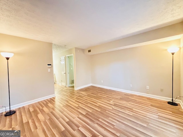 unfurnished room with light wood-type flooring