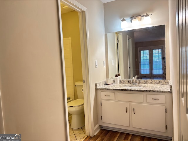 bathroom featuring hardwood / wood-style flooring, vanity, and toilet