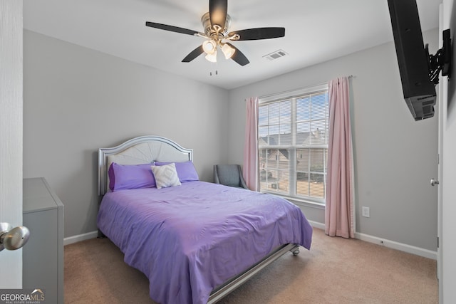 bedroom with ceiling fan and light colored carpet