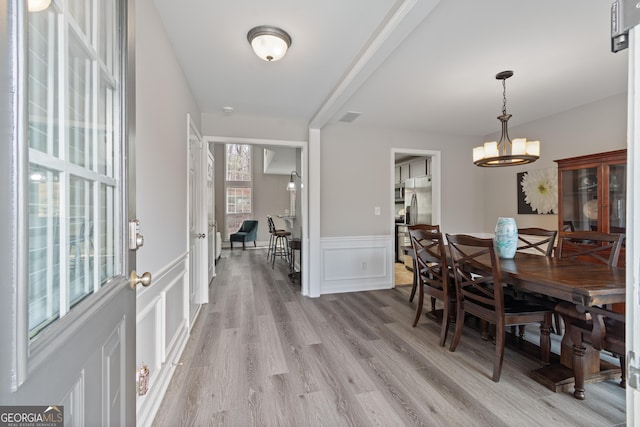 dining space featuring a chandelier and light wood-type flooring